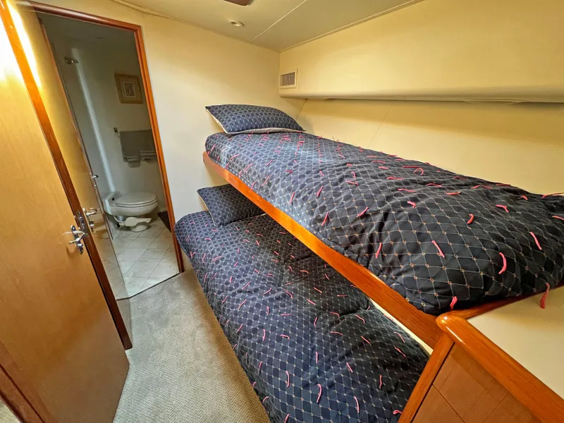 Slide: The Image of Bunk beds in a 1999 Viking 55 yacht cabin with adjacent bathroom. - 37