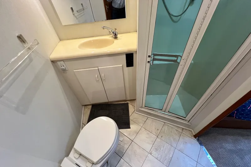 Slide: The Image of Compact bathroom in 1999 Viking 55 yacht with shower, sink, and toilet. - 39