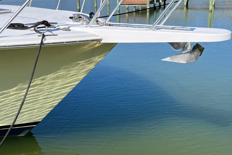 Slide: The Image of Bow of 1999 Viking 55 yacht with anchor, reflecting on calm water. - 4
