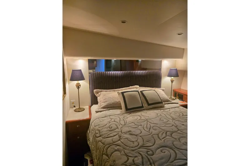 Slide: The Image of Luxurious bedroom interior in 1999 Viking 55 yacht with elegant bedding and lamps. - 41