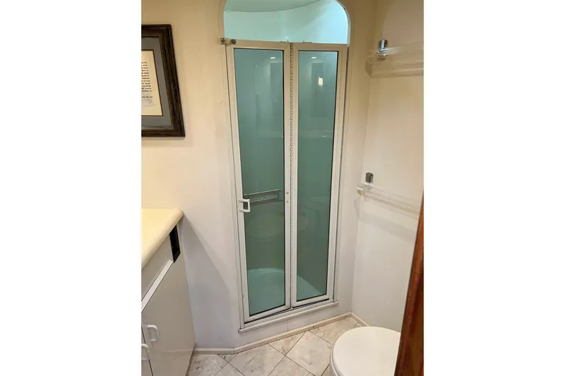 Slide: The Image of Bathroom with glass shower door in 1999 Viking 55 yacht. - 43