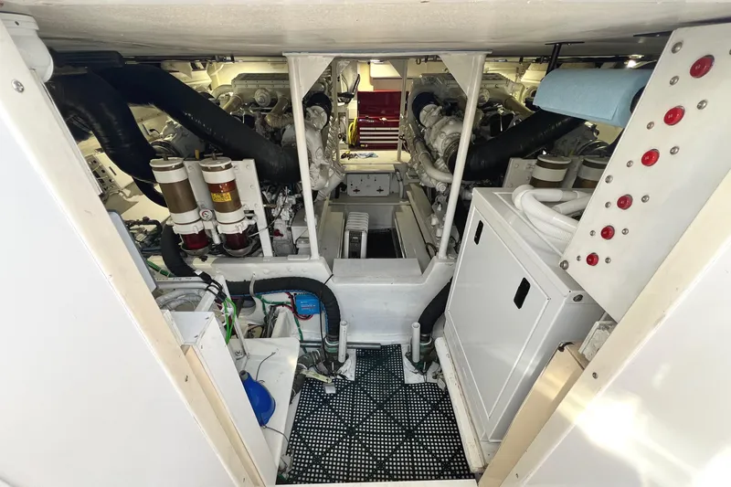 Slide: The Image of Engine room of a 1999 Viking 55 yacht, showcasing machinery and control panels. - 45