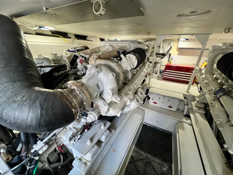 Slide: The Image of Engine room of a 1999 Viking 55 yacht, showcasing mechanical components and systems. - 46