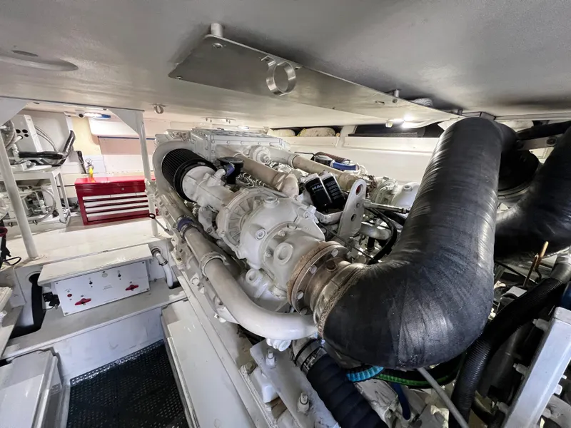 Slide: The Image of Engine room of a 1999 Viking 55 yacht, showcasing detailed machinery and components. - 47