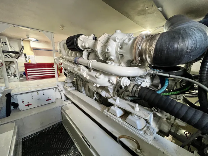 Slide: The Image of Engine room of a 1999 Viking 55 yacht, showcasing detailed machinery and components. - 50