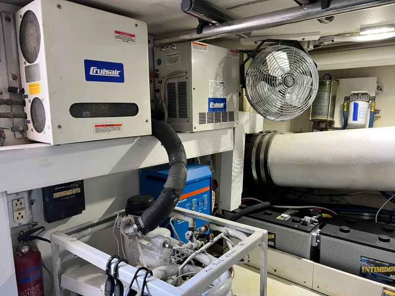 Slide: The Image of Engine room of 1999 Viking 55 yacht with Cruisair systems and ventilation fan. - 51