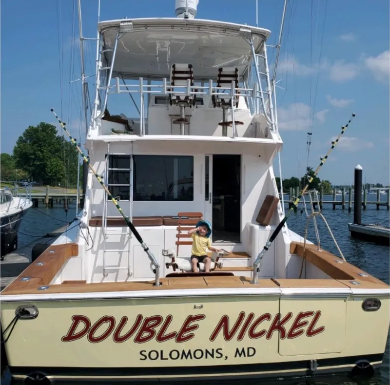 Slide: The Image of 1999 Viking 55 yacht "Double Nickel" docked in Solomons, MD with child seated. - 7