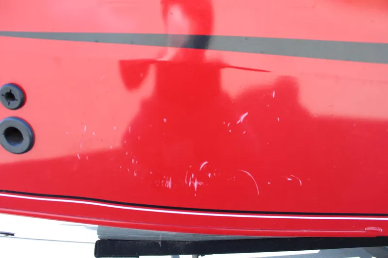 Slide: The Image of 2018 Tracker Pro Guide V-175 SC boat with red exterior and minor scratches. - 11