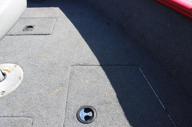 Slide: The Image of 2018 Tracker Pro Guide V-175 SC boat interior with carpeted flooring and storage compartments. - 20