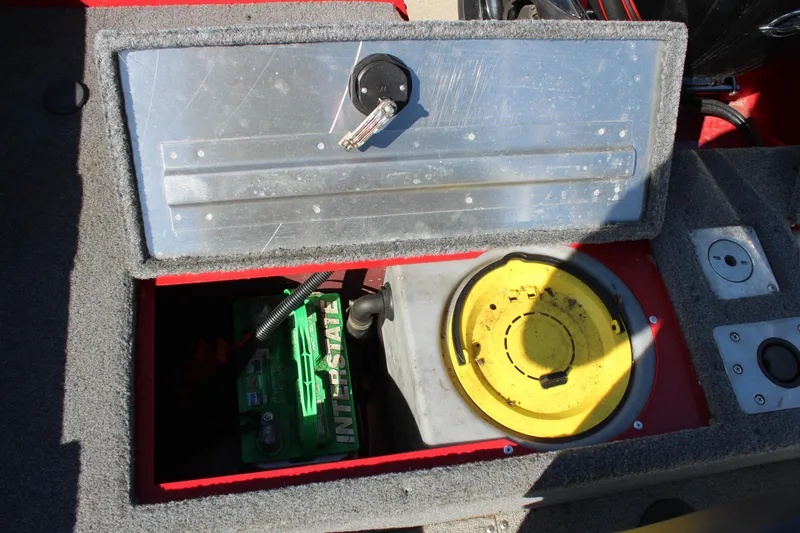 Slide: The Image of 2018 Tracker Pro Guide V-175 SC boat storage compartment with battery and yellow lid. - 27