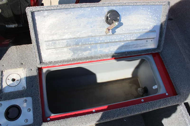 Slide: The Image of 2018 Tracker Pro Guide V-175 SC boat storage compartment with open lid and key. - 28