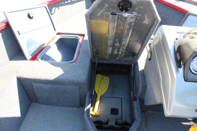 Slide: The Image of 2018 Tracker Pro Guide V-175 SC boat interior with open storage compartments and yellow paddle. - 30