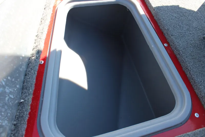 Slide: The Image of Storage compartment of 2018 Tracker Pro Guide V-175 SC boat, featuring red trim and gray interior. - 31