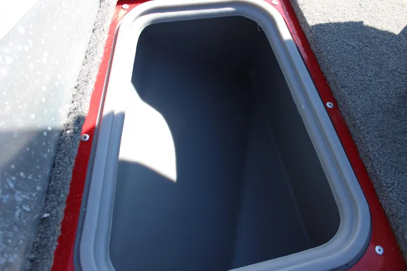 Slide: The Image of Storage compartment of 2018 Tracker Pro Guide V-175 SC boat, featuring red trim and gray interior. - 32