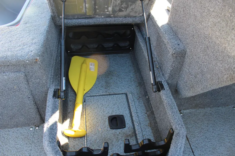 Slide: The Image of 2018 Tracker Pro Guide V-175 SC boat storage compartment with yellow paddle and rod holders. - 33
