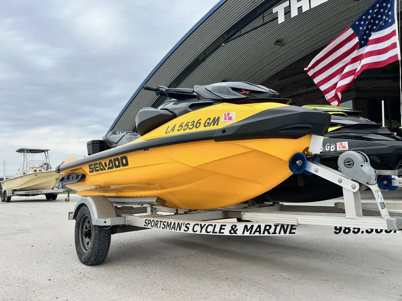 Slide: The Image of 2021 Sea-Doo RXP-X 300 on trailer, parked near American flag. - 1