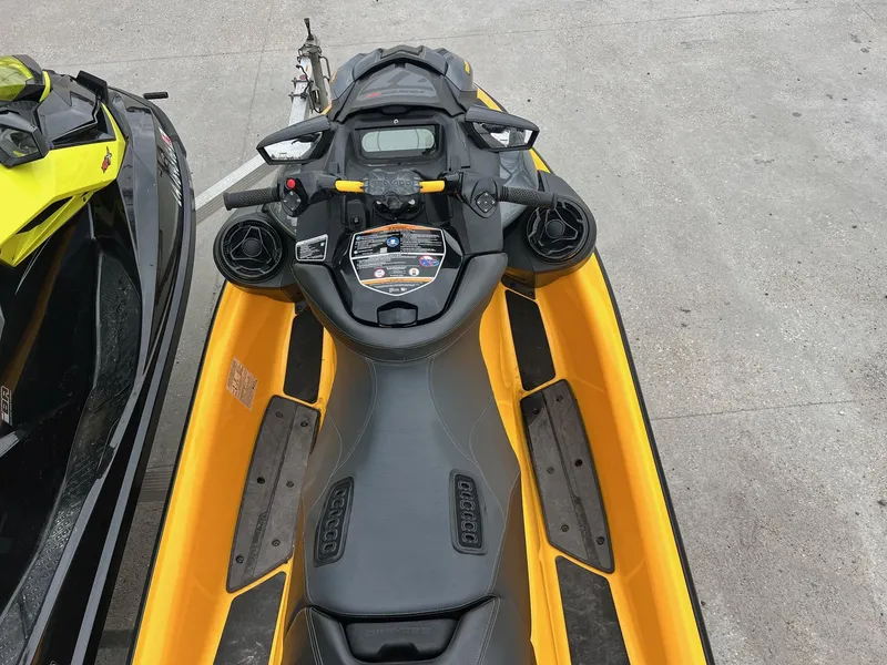Slide: The Image of 2021 Sea-Doo RXP-X 300 jet ski, yellow and black, top view on concrete surface. - 5