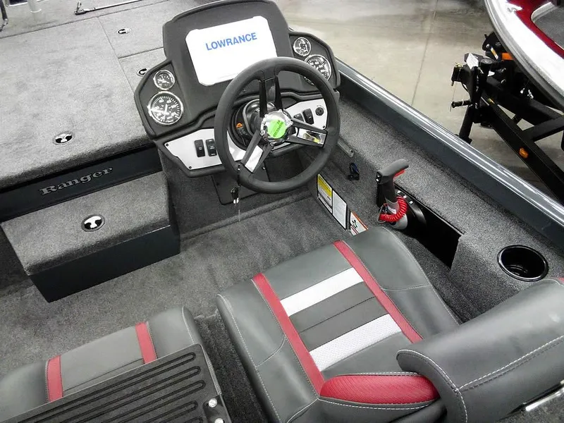 Slide: The Image of 2025 Ranger RT188P boat interior with steering wheel, Lowrance display, and stylish seating. - 23