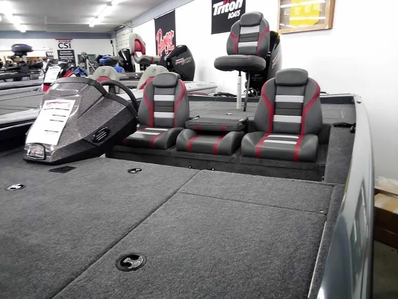 Slide: The Image of 2025 Ranger RT188P boat interior with gray and red seating in showroom. - 5
