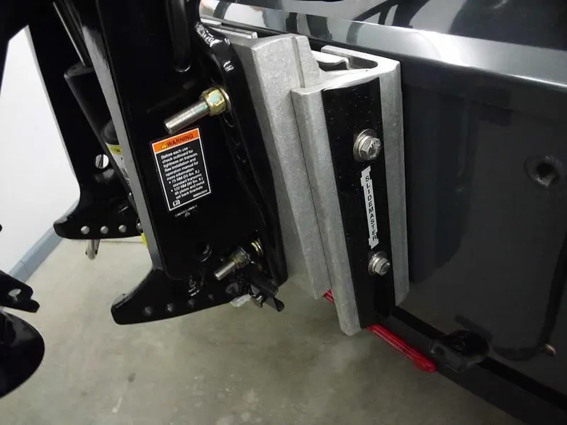 Slide: The Image of 2025 Ranger RT188P boat motor mount detail with bolts and warning label. - 8