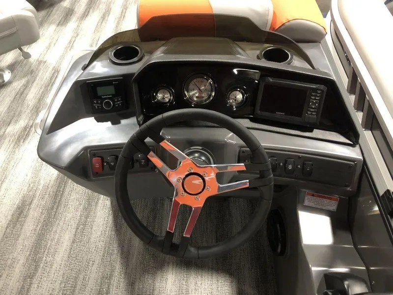 Slide: The Image of 2025 Bennington S L-Bench 23 SL boat dashboard with steering wheel and control panel. - 5