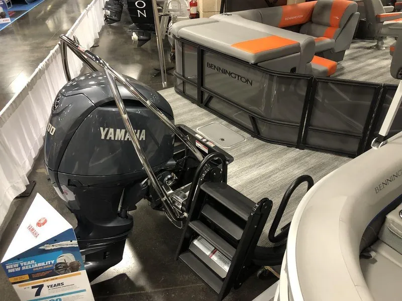 Slide: The Image of 2025 Bennington S L-Bench 23 SL pontoon boat with Yamaha engine at a boat show. - 6