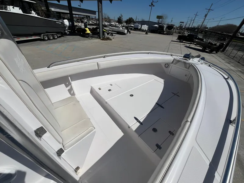 Slide: The Image of 2009 Ocean Runner 29 cc boat, spacious deck, white interior, outdoor marina setting. - 12