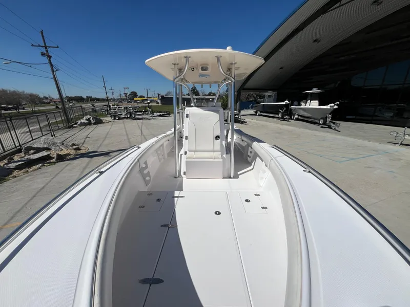 Slide: The Image of 2009 Ocean Runner 29 cc boat with spacious deck and T-top, docked outdoors. - 13