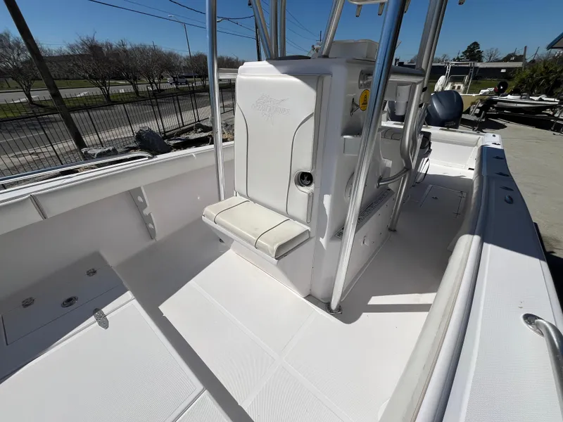 Slide: The Image of 2009 Ocean Runner 29 cc boat interior with white seating and console. - 14