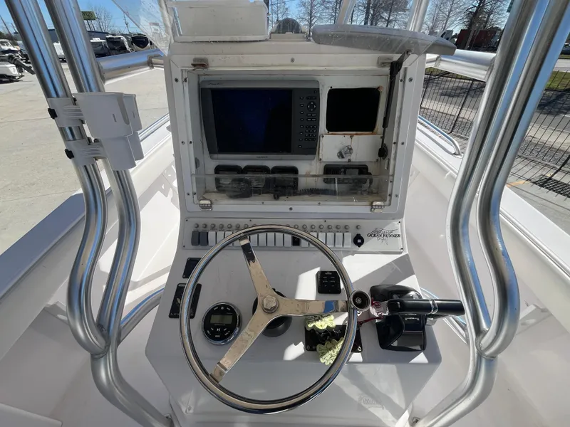 Slide: The Image of 2009 Ocean Runner 29 cc boat console with steering wheel and navigation equipment. - 17