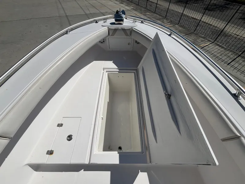 Slide: The Image of 2009 Ocean Runner 29 cc boat with open storage compartment on deck. - 18