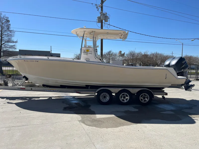 Slide: The Image of 2009 Ocean Runner 29 cc boat on a trailer, parked outdoors. - 5