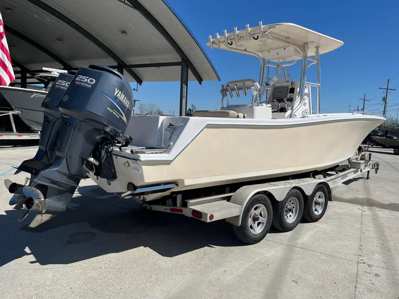Slide: The Image of 2009 Ocean Runner 29 cc boat on trailer with Yamaha engines, parked outdoors. - 8