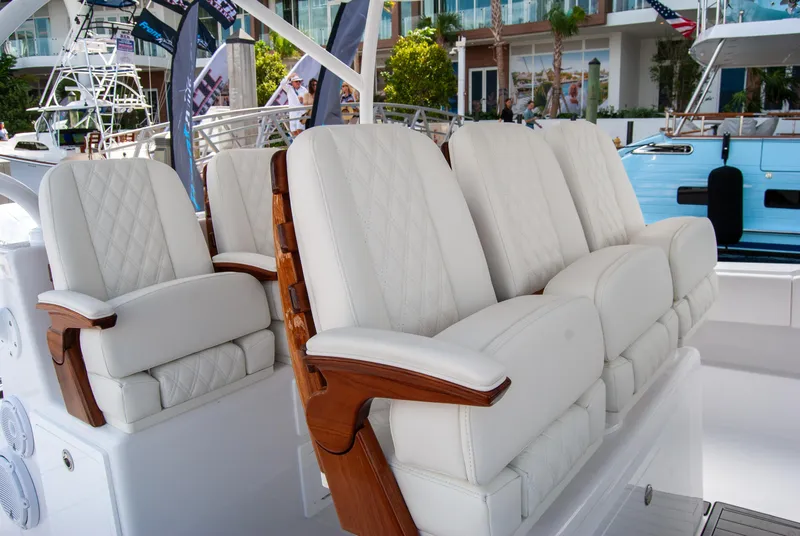 Slide: The Image of Luxurious seating on 2025 Front Runner 43 Catamaran, featuring elegant white upholstery and wooden accents. - 11