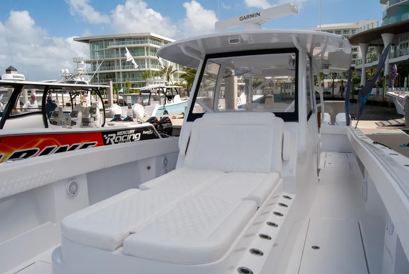 Slide: The Image of 2025 Front Runner 43 Catamaran with white seating, docked at a marina. - 13