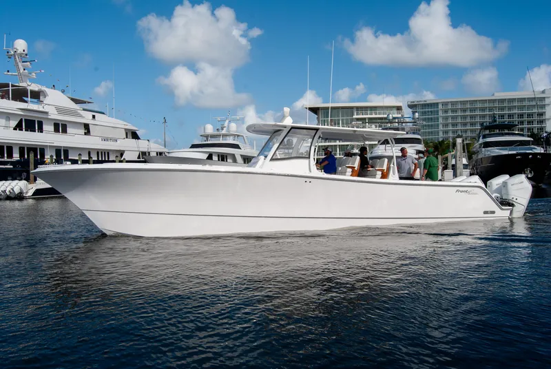 Slide: The Image of 2025 Front Runner 43 Catamaran docked in marina, clear skies, calm water. - 2