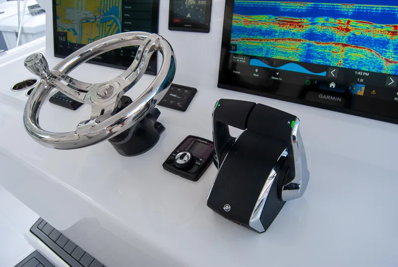 Slide: The Image of Steering console of 2025 Front Runner 43 Catamaran with advanced navigation displays. - 28