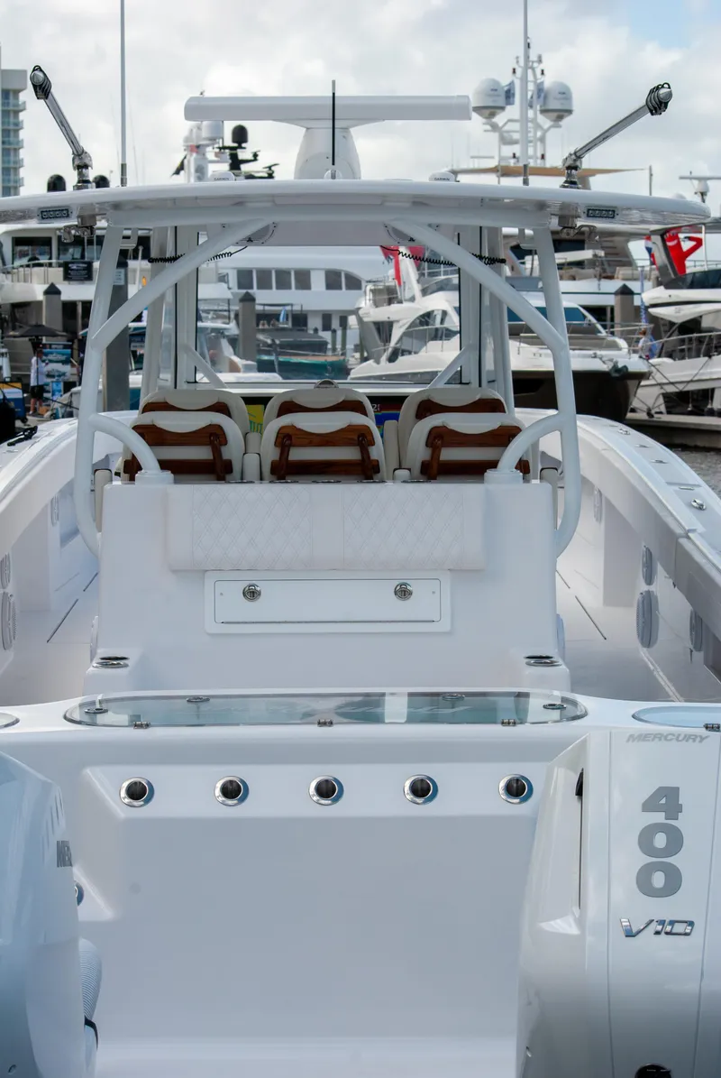 Slide: The Image of 2025 Front Runner 43 Catamaran at marina, showcasing sleek design and powerful engines. - 32