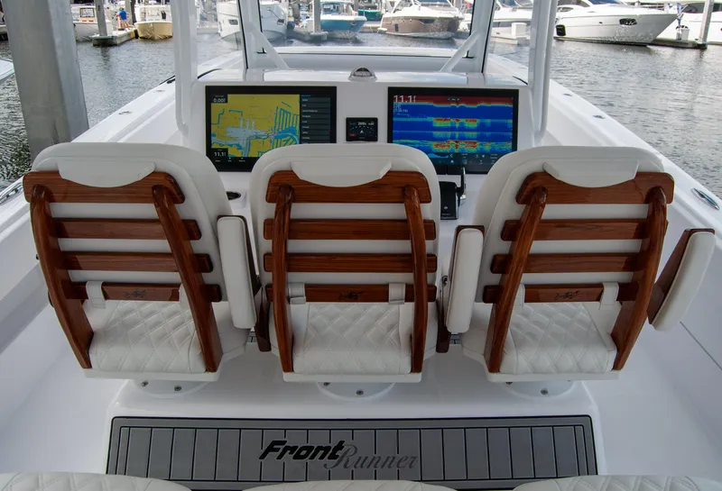 Slide: The Image of 2025 Front Runner 43 Catamaran cockpit with three seats and navigation screens. - 34