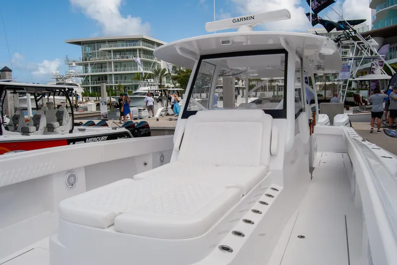 Slide: The Image of 2025 Front Runner 43 Catamaran with white seating at a marina. - 43