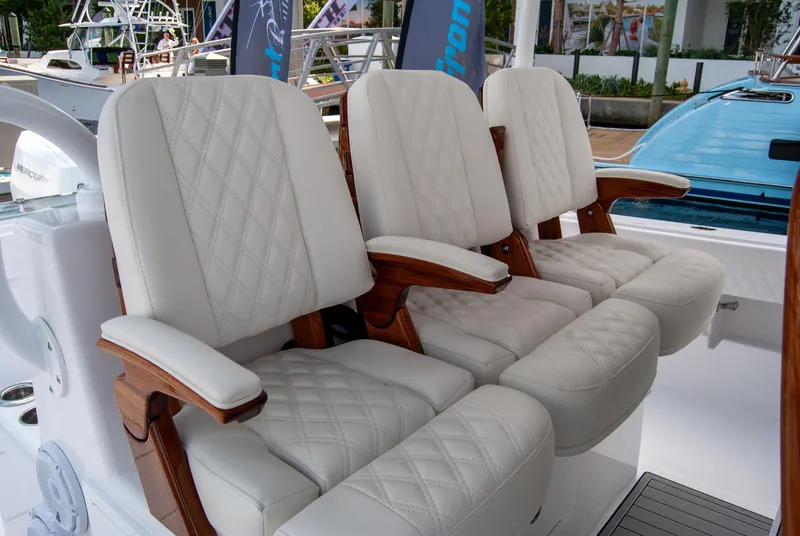 Slide: The Image of Luxury seating on 2025 Front Runner 43 Catamaran, featuring elegant white upholstery and wooden accents. - 6