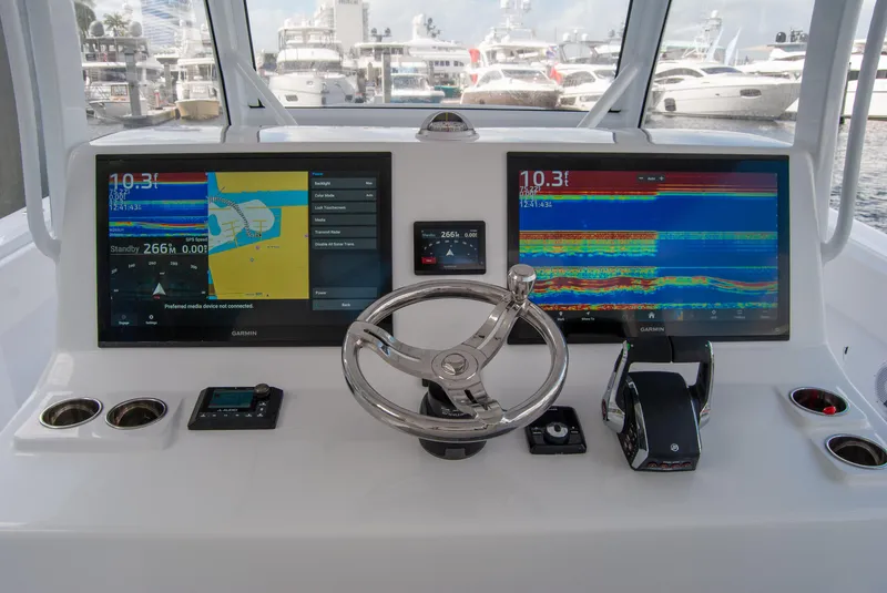 Slide: The Image of Helm of 2025 Front Runner 43 Catamaran with dual navigation screens and steering wheel. - 9
