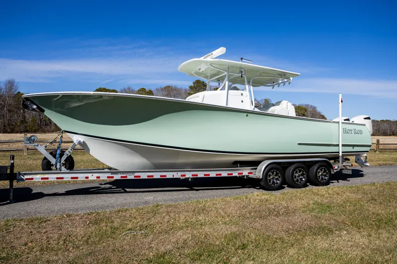 Slide: The Image of 2005 French Yachts 34 Center Console on trailer, parked outdoors under clear blue sky. - 0
