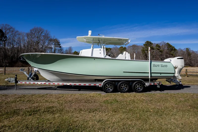 Slide: The Image of 2005 French Yachts 34 Center Console boat on trailer, green hull, outdoors. - 1