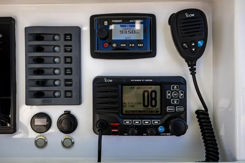 Slide: The Image of Control panel of a 2005 French Yachts 34 Center Console with radio and switches. - 11