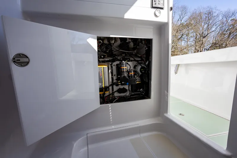 Slide: The Image of Open compartment on 2005 French Yachts 34 Center Console, revealing internal components and wiring. - 15