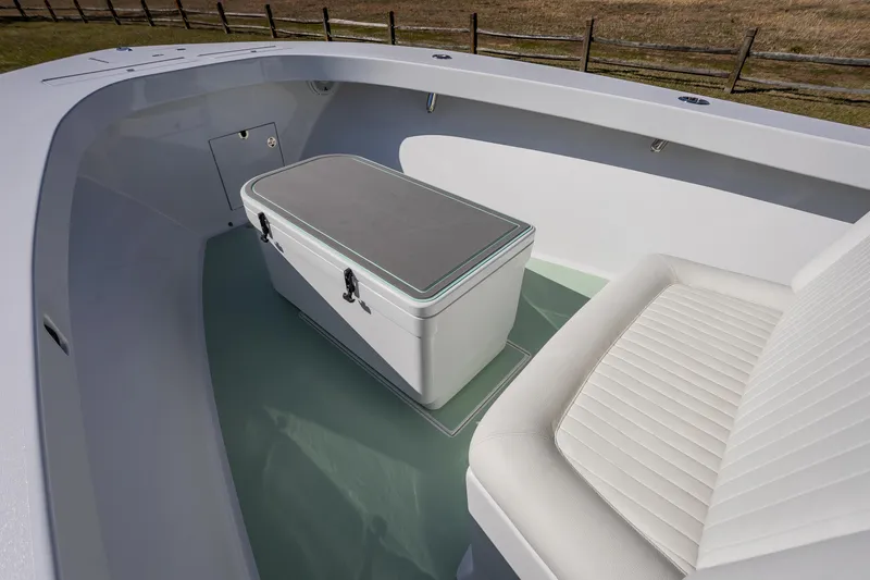 Slide: The Image of 2005 French Yachts 34 Center Console interior with seating and storage compartment. - 19