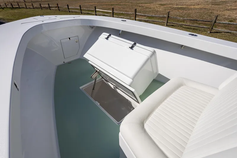 Slide: The Image of 2005 French Yachts 34 Center Console interior with white seating and storage compartment. - 21