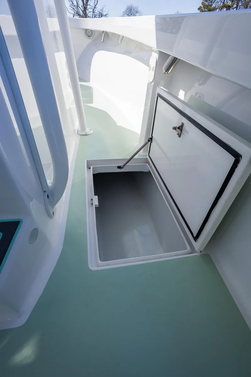 Slide: The Image of Open storage compartment on 2005 French Yachts 34 Center Console boat deck. - 28