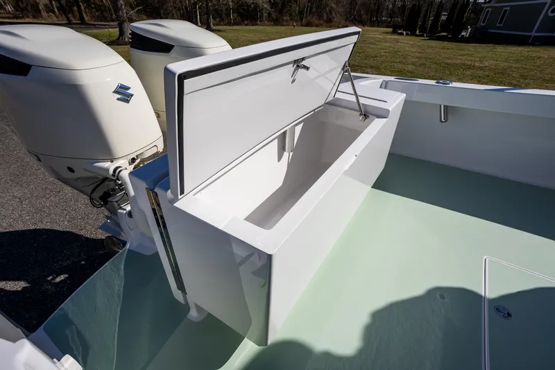 Slide: The Image of 2005 French Yachts 34 Center Console with open storage compartment and dual Suzuki outboard engines. - 34
